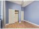 Spacious bedroom with wood-look flooring and closet with doors at 43502 W Kramer Ln, Maricopa, AZ 85138