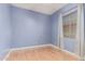 Empty bedroom with wood-look flooring, a large window, and light-colored walls at 43502 W Kramer Ln, Maricopa, AZ 85138