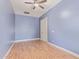 Bright, empty bedroom featuring wood-look floors and light-colored walls at 43502 W Kramer Ln, Maricopa, AZ 85138