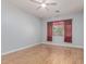 Bright bedroom featuring light-colored walls and wood-look flooring and a ceiling fan at 43502 W Kramer Ln, Maricopa, AZ 85138