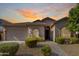 Attractive front exterior with desert landscaping and a two-car garage at 43502 W Kramer Ln, Maricopa, AZ 85138