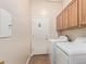 Functional laundry room with washer, dryer, and storage cabinets at 43502 W Kramer Ln, Maricopa, AZ 85138