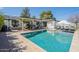 Outdoor oasis featuring a pool, covered patio, lounge chairs, and built-in grill at 4842 E Fairmount Ave, Phoenix, AZ 85018