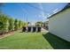 Spacious backyard featuring a lawn, pool, and comfortable lounge chairs, creating a perfect outdoor retreat at 4842 E Fairmount Ave, Phoenix, AZ 85018