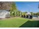 Lush backyard featuring a pool, lounge chairs, manicured lawn, and privacy landscaping for a serene outdoor experience at 4842 E Fairmount Ave, Phoenix, AZ 85018