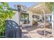 Outdoor patio featuring a hanging chair, barstool seating, grill, and heater, creating a cozy and inviting space at 4842 E Fairmount Ave, Phoenix, AZ 85018
