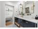 Beautiful bathroom featuring a double vanity, stylish black fixtures, and sleek white tile at 4842 E Fairmount Ave, Phoenix, AZ 85018