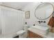 Bright bathroom featuring a round mirror, sleek white sink, and modern fixtures for a minimalist, clean aesthetic at 4842 E Fairmount Ave, Phoenix, AZ 85018