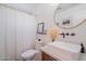 Bathroom featuring modern sink, toilet, and shower with patterned curtain at 4842 E Fairmount Ave, Phoenix, AZ 85018