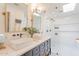 Bright Primary bathroom with double vanity, marble countertops, and a glass enclosed shower at 4842 E Fairmount Ave, Phoenix, AZ 85018