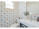 Stylish powder room features patterned tile, modern vanity, and a copper-framed mirror at 4842 E Fairmount Ave, Phoenix, AZ 85018