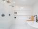 Bright bathroom features white tile, a soaking tub, a glass enclosed shower, and recessed shelving at 4842 E Fairmount Ave, Phoenix, AZ 85018