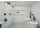 Spa-like bathroom with a soaking tub, dual shower heads, and stylish black fixtures, complete with sleek, white tile at 4842 E Fairmount Ave, Phoenix, AZ 85018