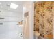 Bright bathroom with floral wallpaper, soaking tub, glass enclosed shower, and patterned floor tiles at 4842 E Fairmount Ave, Phoenix, AZ 85018