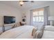 Neutral bedroom with a ceiling fan and bamboo shade covered window at 4842 E Fairmount Ave, Phoenix, AZ 85018