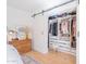 Bedroom closet with white barn door and custom shelving at 4842 E Fairmount Ave, Phoenix, AZ 85018
