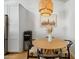 Cozy dining area featuring a modern light fixture, wood table, and bright white walls at 4842 E Fairmount Ave, Phoenix, AZ 85018