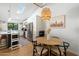 Cozy dining area with modern light fixture, wood table, and white cabinetry at 4842 E Fairmount Ave, Phoenix, AZ 85018