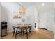 Cozy dining area featuring a modern light fixture, wood table, and adjacent doorway at 4842 E Fairmount Ave, Phoenix, AZ 85018