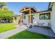 Charming entrance with a decorative wood covering, cozy seating, and mature landscaping at 4842 E Fairmount Ave, Phoenix, AZ 85018