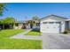 Single-story home with a lush green lawn, stone walkway, and a two-car garage at 4842 E Fairmount Ave, Phoenix, AZ 85018