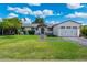 Charming single-story home with lush lawn, brick pathway, and attached two-car garage at 4842 E Fairmount Ave, Phoenix, AZ 85018