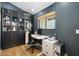 Comfortable home office with dark walls, hardwood floors, and built-in shelving at 4842 E Fairmount Ave, Phoenix, AZ 85018