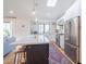 Modern kitchen with stainless appliances, large island, and open floor plan to living area at 4842 E Fairmount Ave, Phoenix, AZ 85018