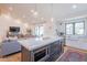 Open concept kitchen features a large island, stainless steel appliances, and a view of the living area at 4842 E Fairmount Ave, Phoenix, AZ 85018