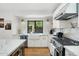 Modern kitchen with stainless steel appliances and a farmhouse sink at 4842 E Fairmount Ave, Phoenix, AZ 85018