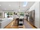 Bright, open kitchen featuring a marble island, stainless steel appliances, and an adjacent living space at 4842 E Fairmount Ave, Phoenix, AZ 85018