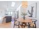 Open-concept kitchen and dining area features stainless appliances, skylight, and seating at the island at 4842 E Fairmount Ave, Phoenix, AZ 85018