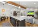 Open-concept living space with a large kitchen island and cozy living room seating area at 4842 E Fairmount Ave, Phoenix, AZ 85018