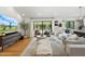Bright living room featuring a large sectional sofa, hardwood floors, and sliding glass doors at 4842 E Fairmount Ave, Phoenix, AZ 85018