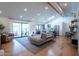 Spacious living area with hardwood floors, an open floor plan, and sliding glass doors at 4842 E Fairmount Ave, Phoenix, AZ 85018