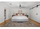 Spacious main bedroom with a large bed, decorative rug, barn door closet, bedside tables and contemporary decor at 4842 E Fairmount Ave, Phoenix, AZ 85018