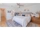 Bright bedroom with a queen sized bed, wood floors, and decorative hats hanging on a coat rack at 4842 E Fairmount Ave, Phoenix, AZ 85018