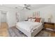 Spacious main bedroom with a large bed, decorative rug, bedside tables and contemporary decor and connected bathroom at 4842 E Fairmount Ave, Phoenix, AZ 85018
