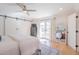 Cozy bedroom with sliding barn doors, light wood floors, and an en-suite view at 4842 E Fairmount Ave, Phoenix, AZ 85018