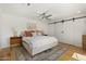 Spacious main bedroom with a large bed, decorative rug, barn door closet, bedside tables and contemporary decor at 4842 E Fairmount Ave, Phoenix, AZ 85018