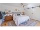 Inviting bedroom with a sliding barn door, ceiling fan, and natural light; complete with a comfortable bed and stylish decor at 4842 E Fairmount Ave, Phoenix, AZ 85018