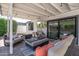 Stylish outdoor patio area perfect for lounging, complete with comfortable seating, a mounted TV, and covered pergola at 4842 E Fairmount Ave, Phoenix, AZ 85018