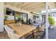 Inviting covered patio with comfortable seating, wooden table, string lights, and outdoor television at 4842 E Fairmount Ave, Phoenix, AZ 85018
