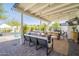 Outdoor patio with shaded seating, dining area, and a view of the sparkling pool at 4842 E Fairmount Ave, Phoenix, AZ 85018