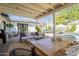Charming patio featuring comfortable seating, dining table, pool, and lush greenery at 4842 E Fairmount Ave, Phoenix, AZ 85018