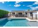 The pool area is fenced for safety and includes a covered patio for relaxation at 4842 E Fairmount Ave, Phoenix, AZ 85018