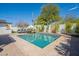 Relaxing backyard featuring a sparkling pool, lounge chairs, and lush landscaping perfect for outdoor entertaining at 4842 E Fairmount Ave, Phoenix, AZ 85018