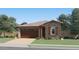 Charming single-story home featuring stone accents, a two-car garage and well manicured lawn at 4951 S 233Rd Dr, Buckeye, AZ 85326
