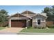 Charming single-story home featuring a two-car garage and manicured lawn at 4963 S 233Rd Dr, Buckeye, AZ 85326