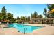 Resort-style community pool with various seating areas, shaded picnic spots and lush landscaping at 5136 E Evergreen St # 1053, Mesa, AZ 85205